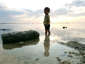 Full length of boy standing at beach