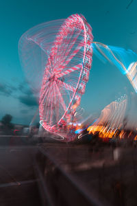 Low angle view of ferris wheel at night