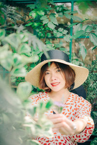 Portrait of a smiling young woman wearing hat