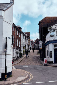 Rye, east sussex, england. view looking up an old cobblestoned street with old tudor-style houses. 