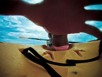 Low section of woman standing on beach