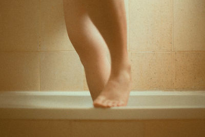 Low section of man standing in bathroom