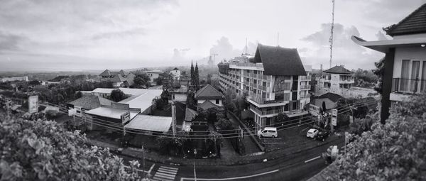 Buildings against cloudy sky