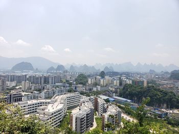 High angle view of buildings in city against sky