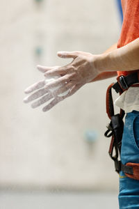 Midsection of man holding umbrella