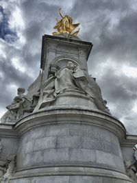 Low angle view of statue against cloudy sky