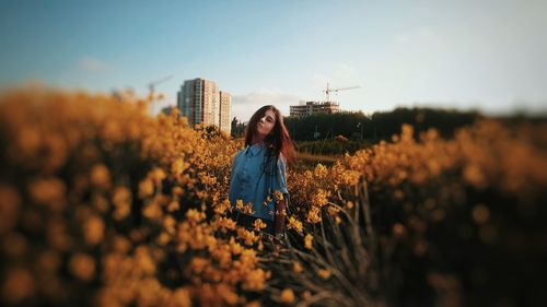 Woman standing on field against sky