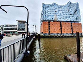 View of bridge over canal against buildings in city