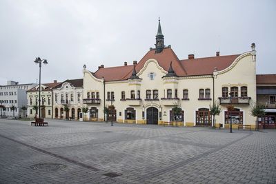 Buildings in town against sky