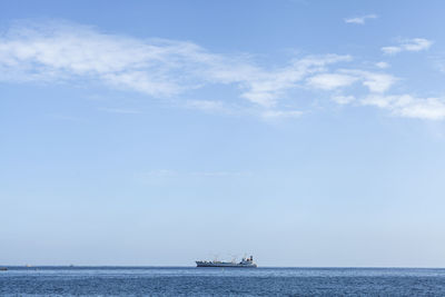 Ship sailing on sea against sky