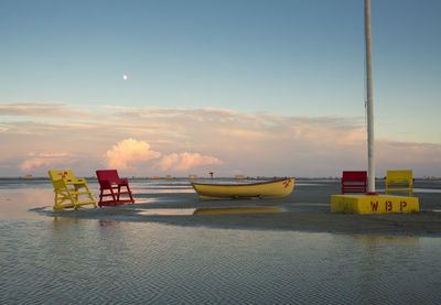 Scenic view of beach against sky during sunset