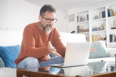 Young woman using laptop at home