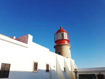 Low angle view of lighthouse against blue sky