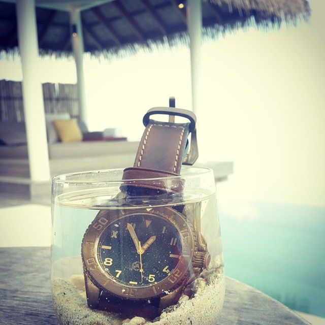 close-up, focus on foreground, metal, water, still life, sea, single object, no people, table, indoors, day, metallic, old, number, old-fashioned, reflection, technology, selective focus, wood - material