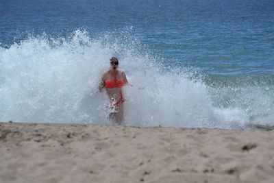 Man splashing water in sea