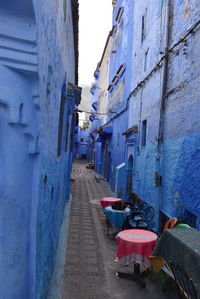 Empty alley amidst buildings in city