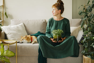 Home gardening and phyto design. funny woman holding diy florarium