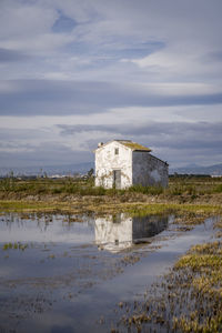 Reflection of a house in the rice fields in spain