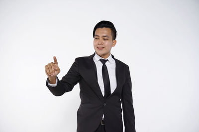 Young man standing against white background