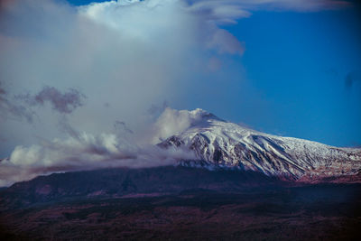 Scenic view of mountains against sky during winter