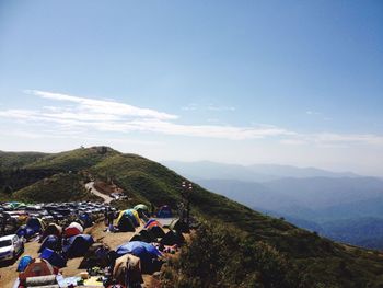 People on mountain against sky