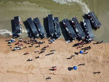 Aerial view people buy seafood at seashore from fisherman.