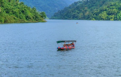 Boat in river against mountains