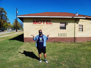 Full length of man standing against building