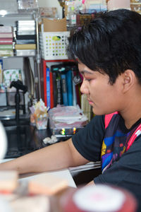 Portrait of a teenage girl sitting in front of a computer, typing