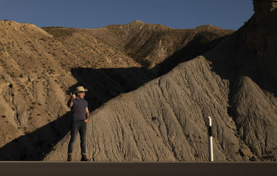 Rear view of man standing on mountain