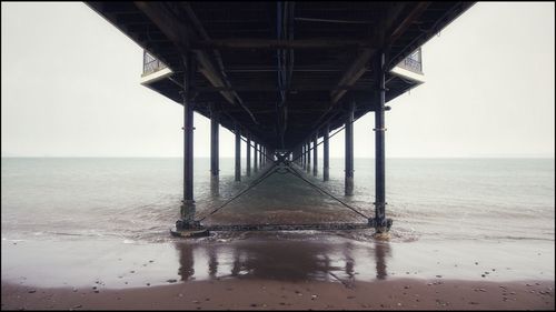 Pier over sea against sky