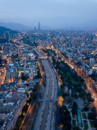 High angle view of illuminated street amidst buildings in city