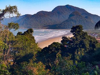 Scenic view of sea and mountains against sky