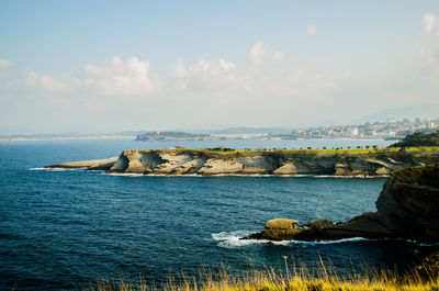 Scenic view of calm sea against cloudy sky