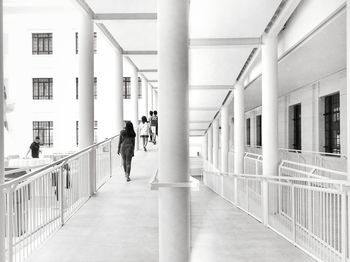 People walking in corridor of building