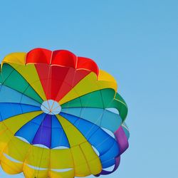 Low angle view of hot air balloon against clear blue sky