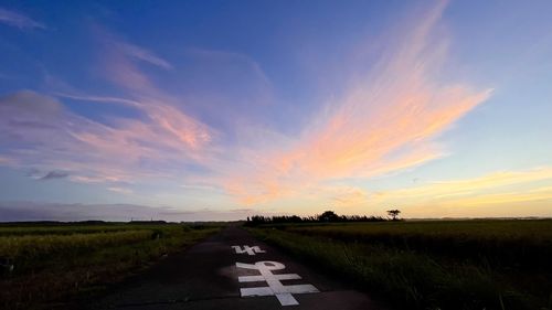 Scenic view of road against sky during sunset