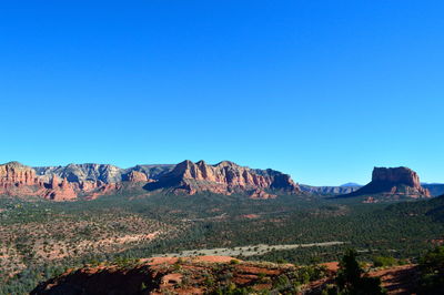 Scenic view of mountain against blue sky