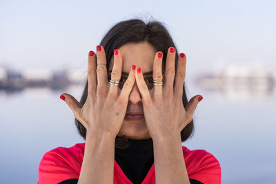 Portrait of young female athlete is playing with her hands on a boat in the harbor