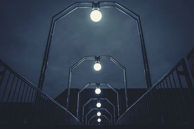 Low angle view of illuminated street light against sky