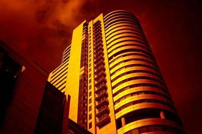 Low angle view of illuminated building against sky at night