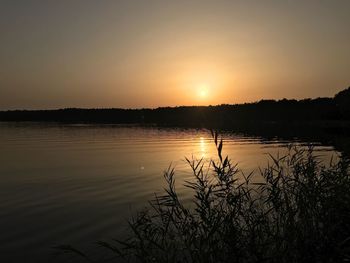 Scenic view of lake against sky during sunset