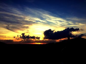 Silhouette trees against sky during sunset