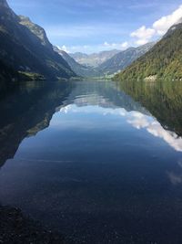 Scenic view of lake and mountains against sky