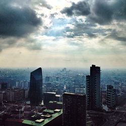 Cityscape against cloudy sky