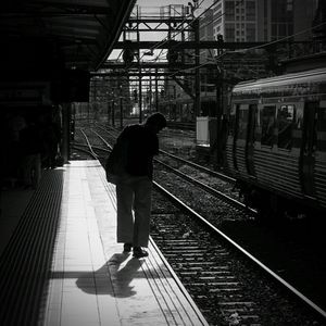 Woman standing on railroad track