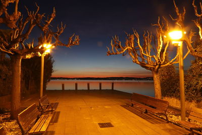 Illuminated lights by swimming pool at night