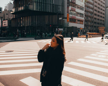 Full length of man crossing road