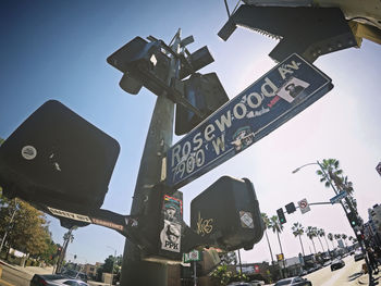 Low angle view of road sign against sky