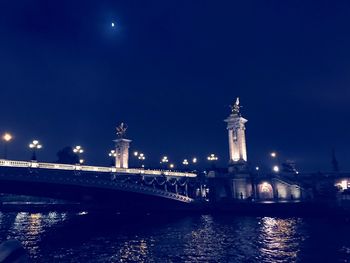 Statue of illuminated city at night